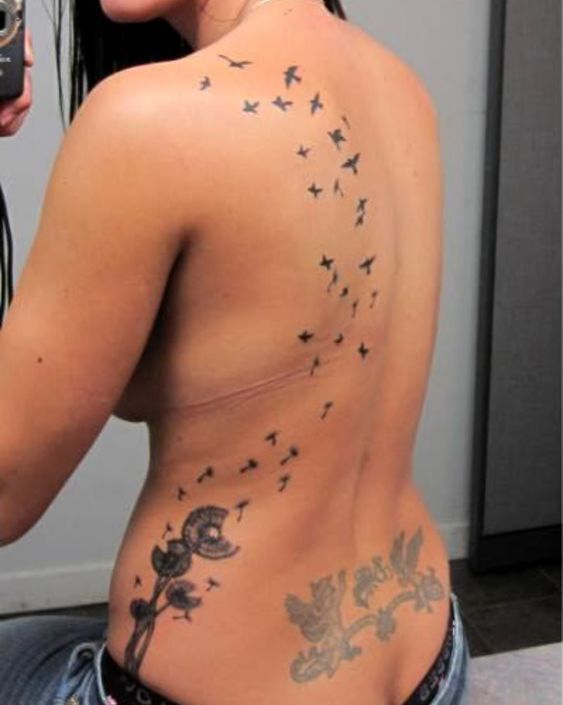 mẫu tattoo dọc lưng đàn chim và cánh hoa bay